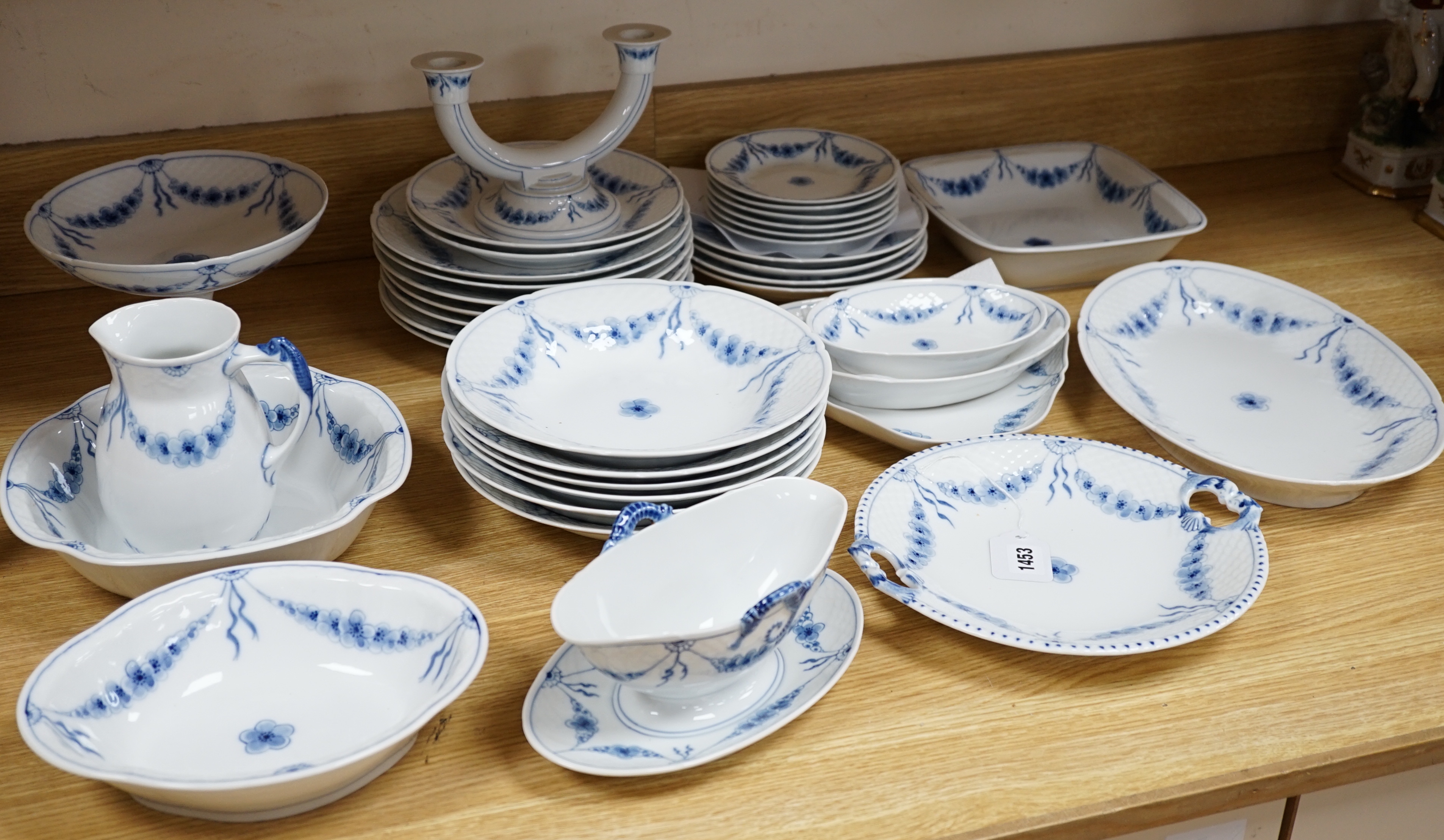 A Bing and Grondahl, Denmark blue and white ‘Empire’ pattern dinner service, thirty-eight pieces including; a cake, stand, candlestick, dinner, plates, jug, serving, dishes, etc.